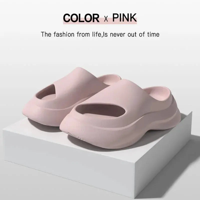 Light pink slip-on sandals with thick soles displayed on a white platform.