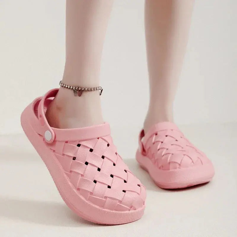 Pink woven slip-on sandals with back strap, worn indoors, showing stylish casual footwear
