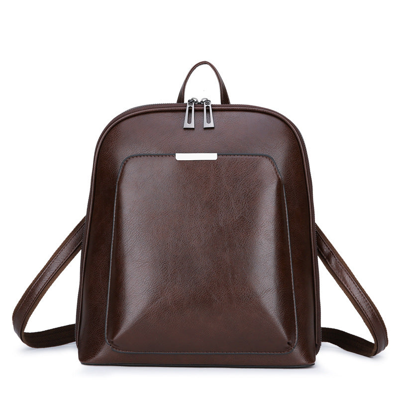 Structured PU Leather Backpack — detail of dual-zip top closure and front slip pocket