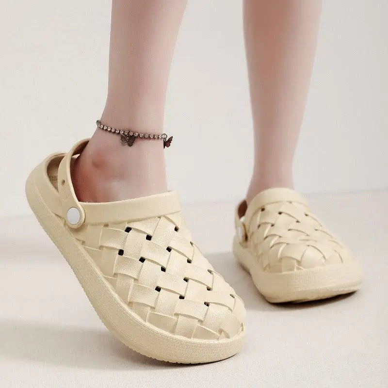 Beige woven slip-on sandals with adjustable strap, worn with a butterfly anklet.