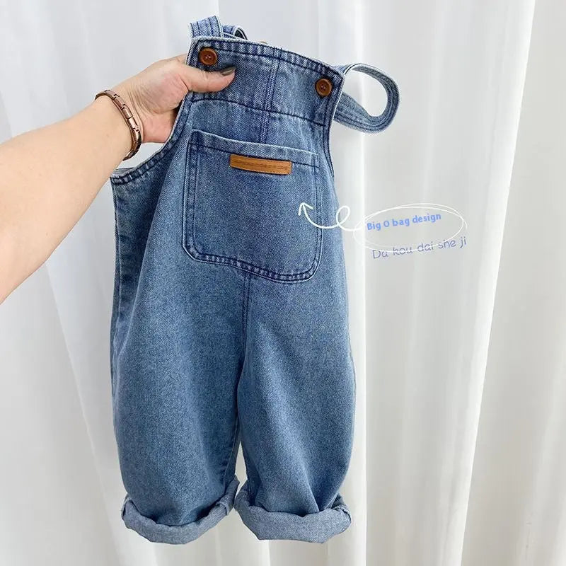 Childrens denim overalls by Undefyning Lynes featuring classic style, durable fabric, and adjustable straps for little explorers.