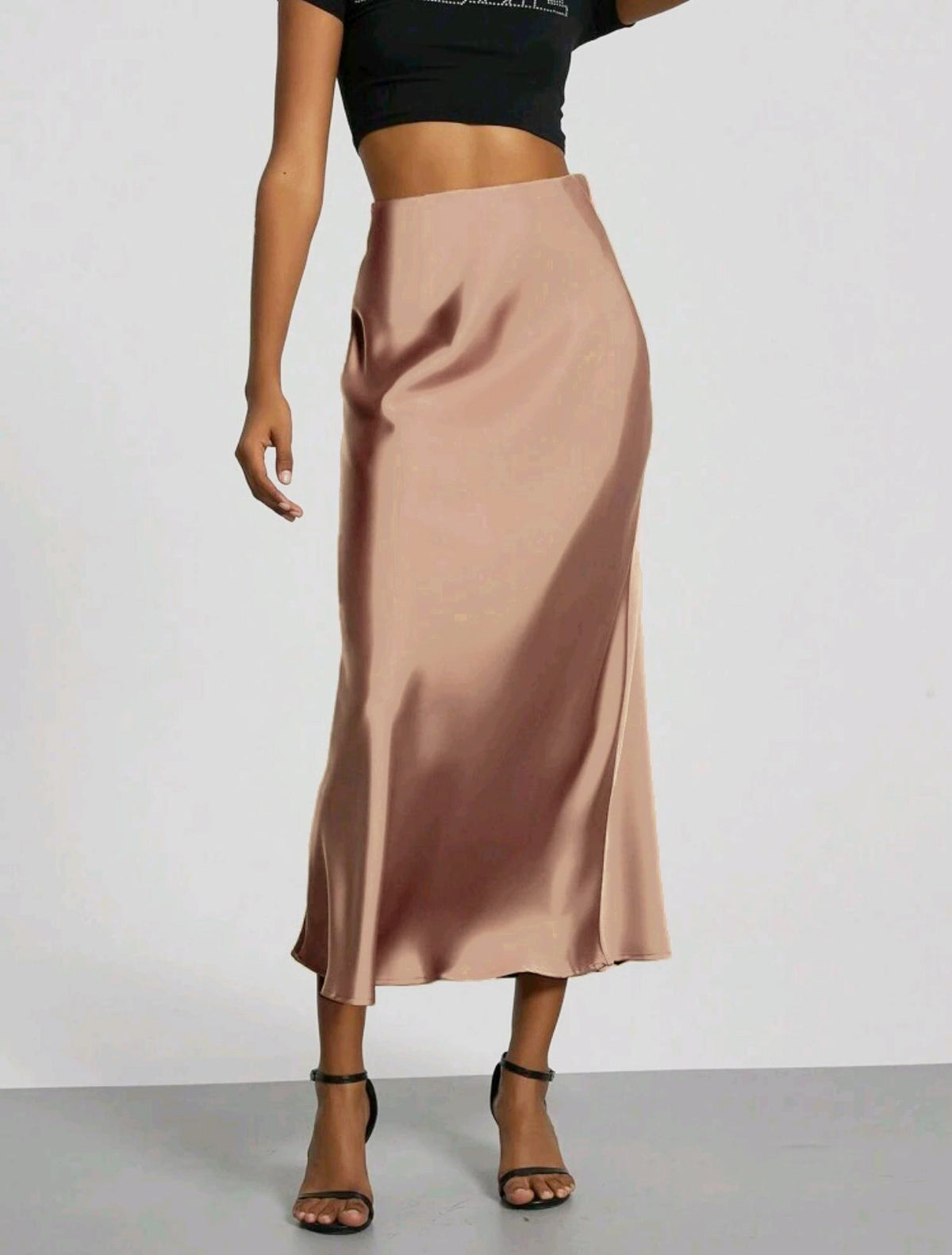 Satin midi skirt in black worn with a plain top