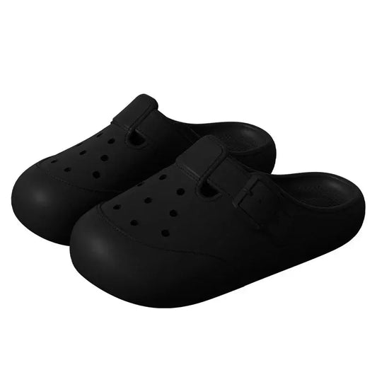 Black slip-on clogs with ventilation holes and buckle detail, casual footwear
