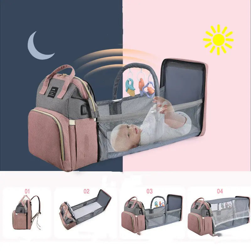 Large capacity pink and grey diaper backpack converts into a portable baby bassinet with mesh sides and toy bar.