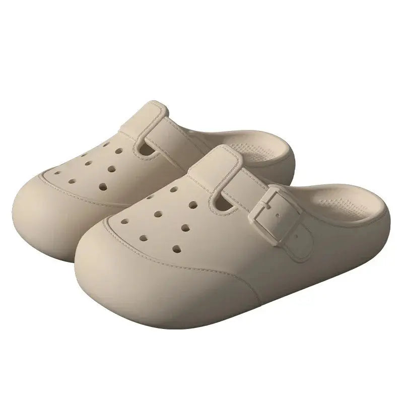 Beige slip-on clogs with ventilation holes and buckle detail, casual footwear