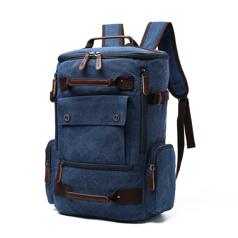 Undefyning Lynes dark blue washed canvas laptop backpack with brown microfiber leather trim and multiple zip pockets.