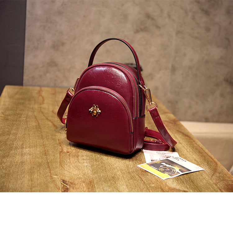 Undefyning Lynes burgundy oil wax leather convertible shoulder bag with bee emblem and adjustable strap