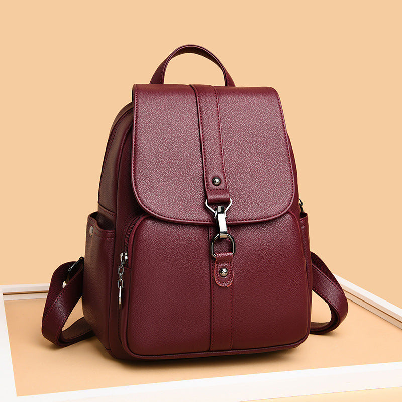 Undefyning Lynes burgundy sheepskin leather backpack with a vertical square silhouette and metal clasp closure.